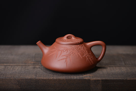 A qingqing carved Eziye stone scoop Zisha teapot with bottom groove